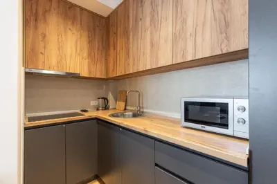 a small kitchen with a microwave and a sink at Apartment LEMON in Becici