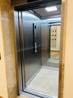 a glass elevator in a room with a mirror at Apartment LEMON in Becici