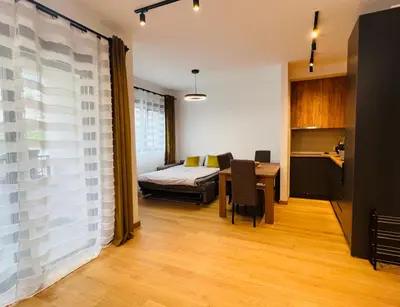 a bedroom with a bed and a table in a room at Apartment LEMON in Becici