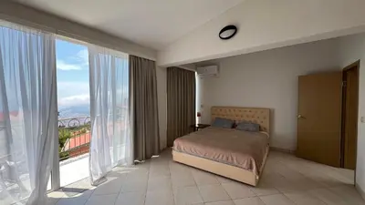 a bedroom with a bed and a large window at Marcovici mountain breeze in Markovići