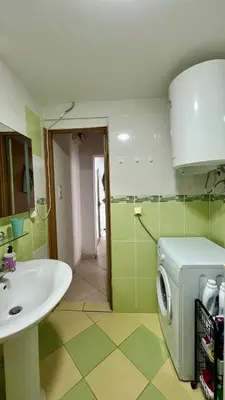 a bathroom with a sink and a washing machine at Marcovici mountain breeze in Markovići