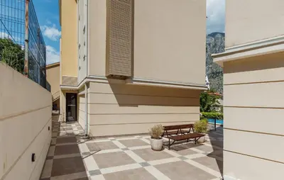 a patio with a bench next to a building at Pool Home near the Old Town in Kotor