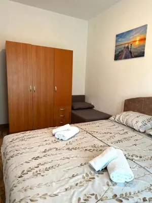 a bedroom with a bed with two towels on it at Apartments Tijana in Tivat