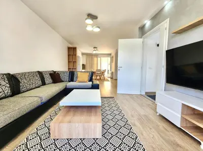a living room with a couch and a flat screen tv at Apartments Bella Notte in Ulcinj