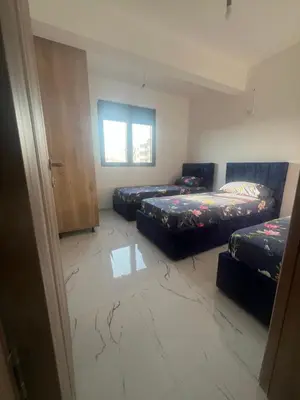 a room with three beds and a window at Apartments Bella Notte in Ulcinj