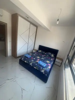a bedroom with a bed in the corner of a room at Apartments Bella Notte in Ulcinj