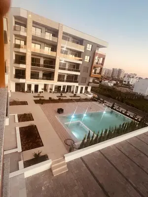 a large building with a swimming pool in front of it at Apartments Bella Notte in Ulcinj