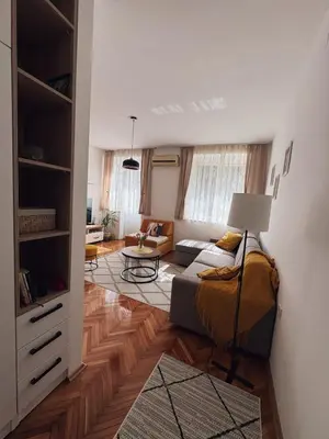 a living room with a couch and a table at Shi Apartment Bar in Bar