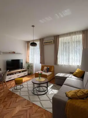 a living room with a couch and a table at Shi Apartment Bar in Bar