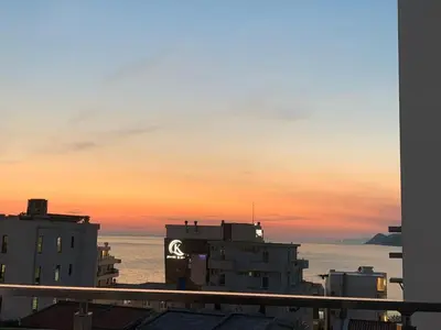 a view of the ocean from a building at sunset at Stan 15 in Dobra Voda