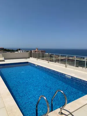 a swimming pool with a view of the ocean at Stan 15 in Dobra Voda
