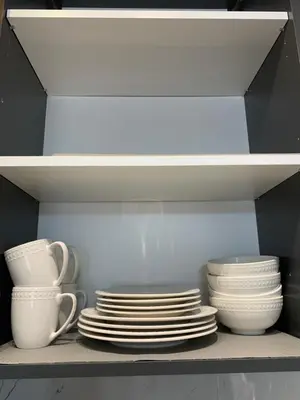 a stack of plates and cups on a shelf at Mountain view in Budva