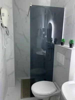 a bathroom with a toilet and a sink and a shower at Mountain view in Budva