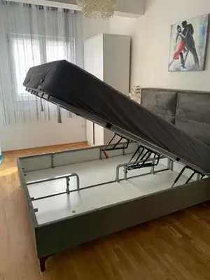 a bed with a sheet on it in a living room at Mountain view in Budva