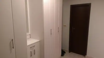 a bathroom with a black door and a white cabinet at Paladium Apartment in Budva