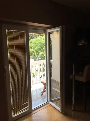 an open sliding glass door with a view of a balcony at Paladium Apartment in Budva