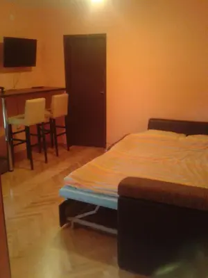 a bedroom with a bed and a table and chairs at Paladium Apartment in Budva