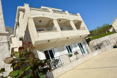 a large stone building with a balcony on top of it at Apartments Jovanovic in Kotor