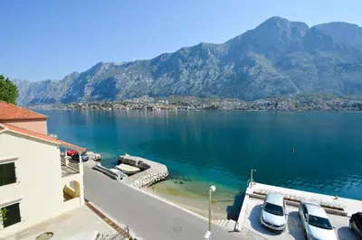 a view of a large body of water with mountains at Apartments Jovanovic in Kotor