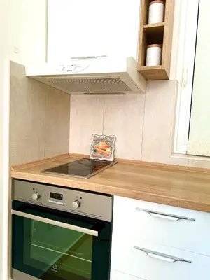 a kitchen with a stove and a counter top at Spacious two bedroom apartment with free parking in Dobrota