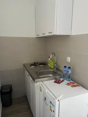 a small kitchen with a sink and a counter at Apartmani Dasic in Sutomore