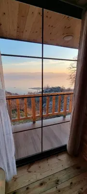 a view from the balcony of a cabin with a large window at Home Livari Viewpoint in Livari