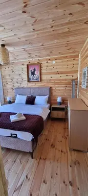 a bedroom with a bed in a wooden cabin at Home Livari Viewpoint in Livari