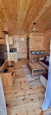 a log cabin with a living room with wooden floors at Home Livari Viewpoint in Livari