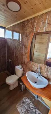 a bathroom with a sink and a toilet and a mirror at Home Livari Viewpoint in Livari