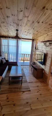 a living room with a couch and a table at Home Livari Viewpoint in Livari