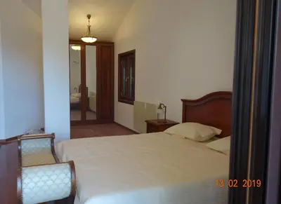 a bedroom with a bed and a chair in it at PerDo in Perazića Do