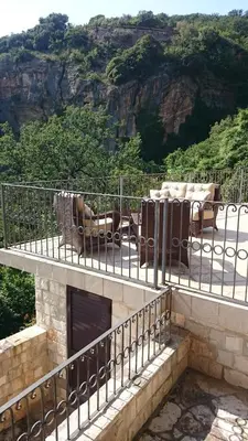 a balcony of a house with chairs and a table at PerDo in Perazića Do