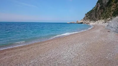 a beach with a rocky shore and the ocean at PerDo in Perazića Do
