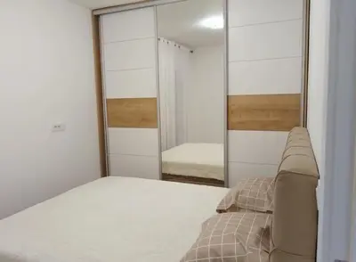a bedroom with a bed and a mirror at Maja 12 in Podgorica