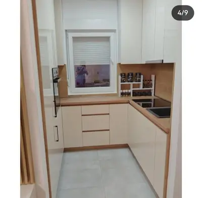 a kitchen with white cabinets and a window at Maja 12 in Podgorica