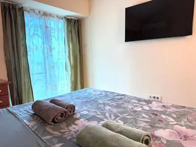 a bedroom with a bed with towels on it at Adriatic Home in Pržno