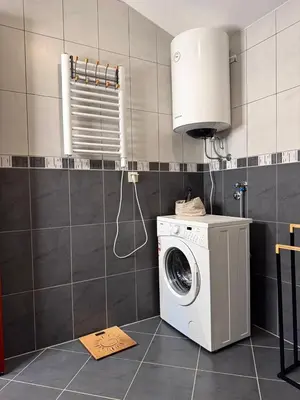 a washing machine in a kitchen with a sink at Adriatic Home in Pržno