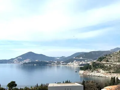 a view of a large body of water with mountains at Adriatic Home in Pržno