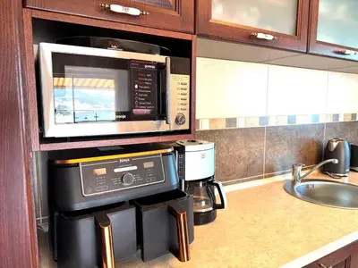 a kitchen with a microwave and a coffee maker at Adriatic Home in Pržno