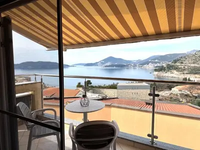a view from a balcony with a table and chairs at Adriatic Home in Pržno