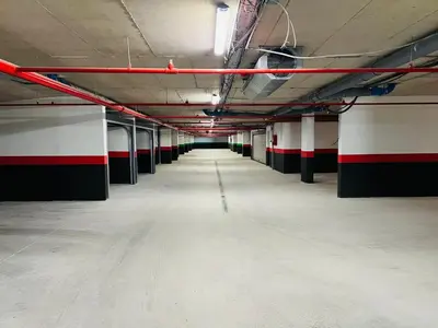an empty parking garage with red and white stripes at Apartment FORTUNELLA in Becici