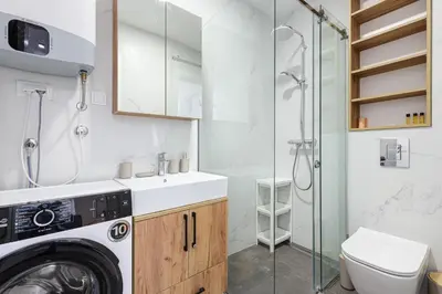 a bathroom with a washing machine and a shower at Apartment FORTUNELLA in Becici