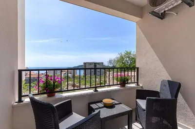 a balcony with chairs and a view of the ocean at Apartment FORTUNELLA in Becici