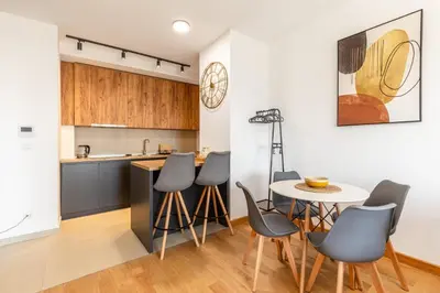 a kitchen and dining room with a table and chairs at Apartment FORTUNELLA in Becici