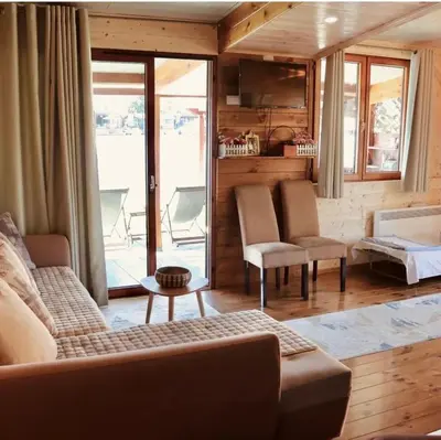 a living room with a couch and chairs and a window at Vuk - Ada Bojana in Ulcinj