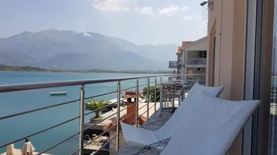 a balcony with a view of a body of water at Apartmani Bonaca in Tivat