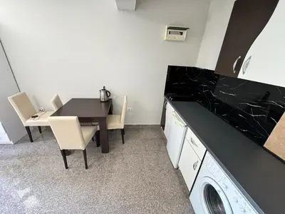 a kitchen with a table and a table and chairs at Apartment Petar in Petrovac na Moru