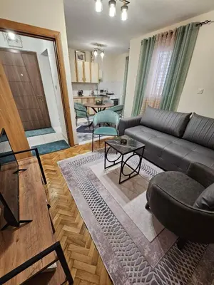 a living room with a couch and a table at Mimoza Apartment in Budva in Budva