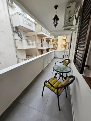 a room with two chairs and a table on a balcony at Mimoza Apartment in Budva in Budva