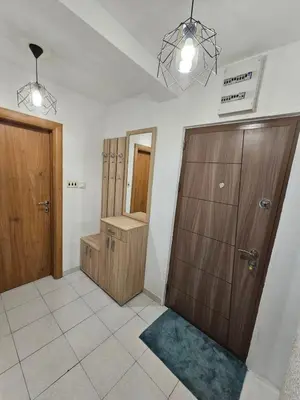 a bathroom with two wooden cabinets and a sink at Mimoza Apartment in Budva in Budva